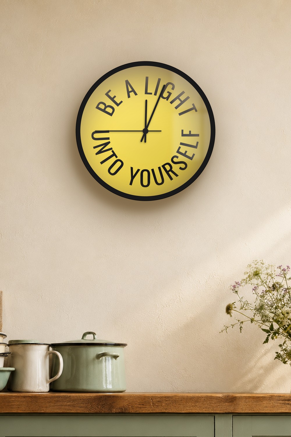 "be a light unto yourself" wall clock in light yellow and near-black zinc, on a wall