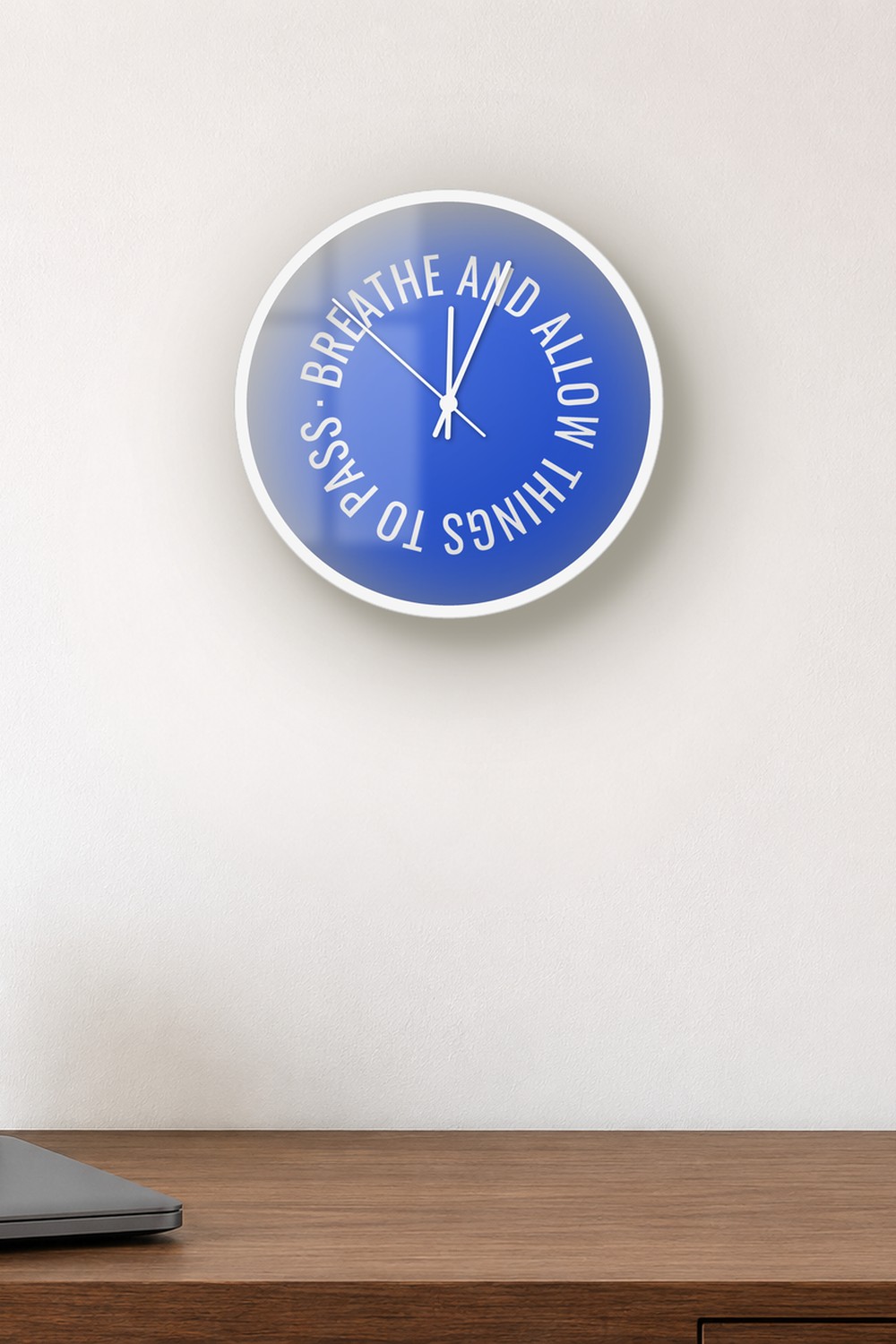 "breathe and allow things to pass" wall clock in deep blue and white, on a wall