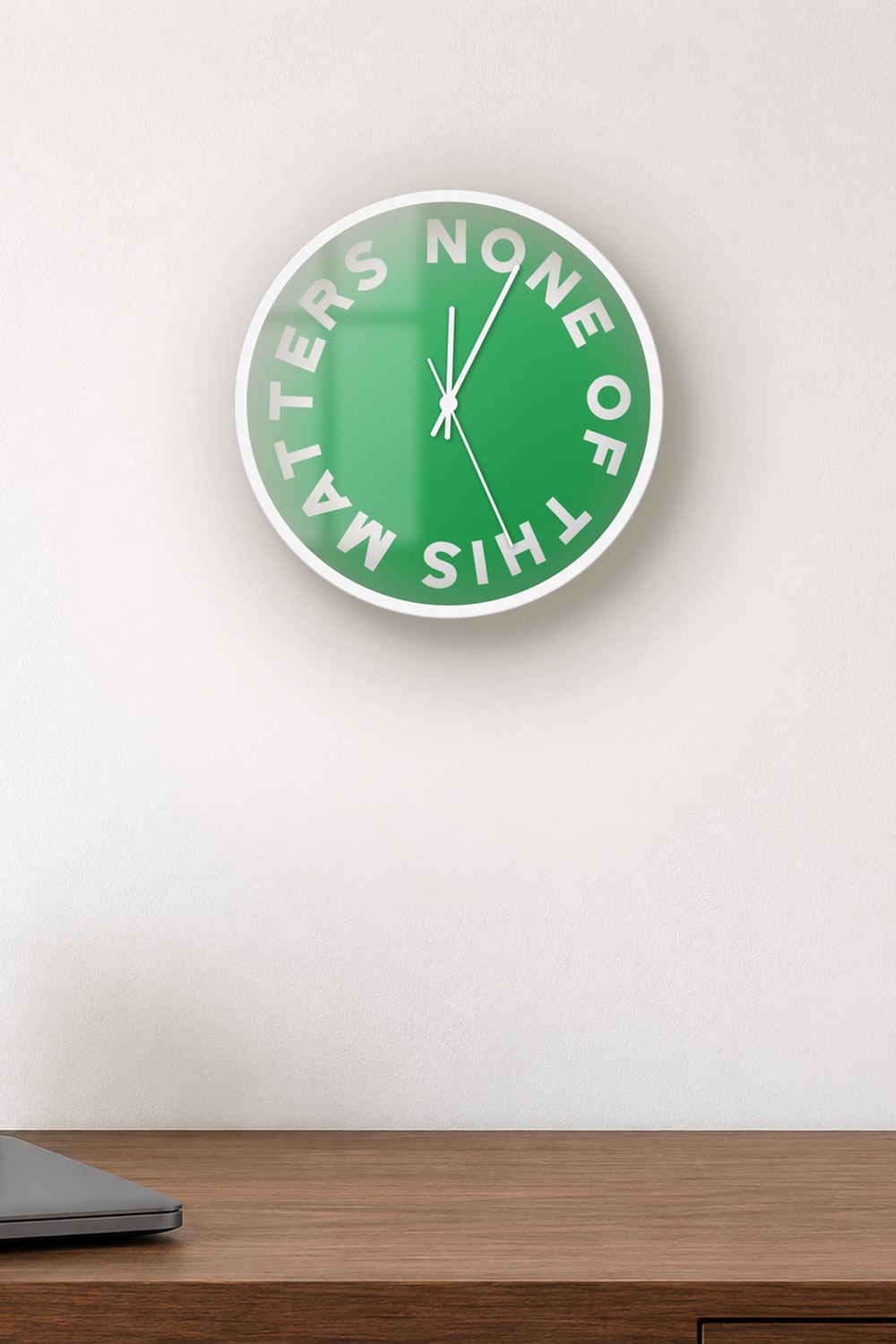 "None of this matters" wall clock in green and white, on a wall