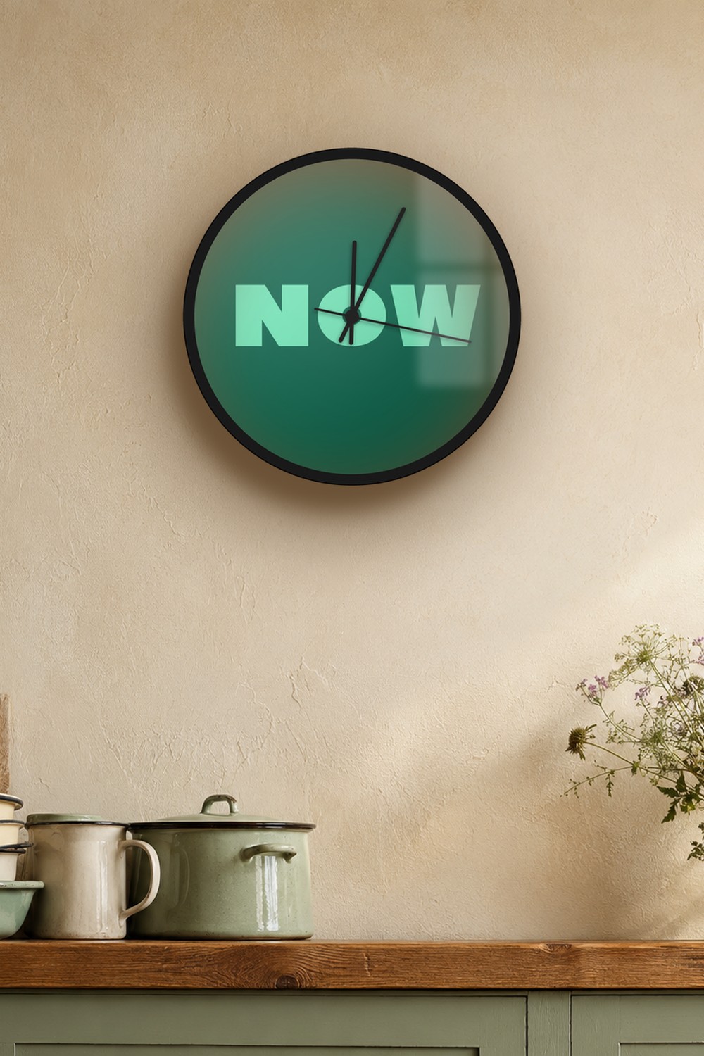 "now" wall clock in dark emerald and light emerald, on a wall