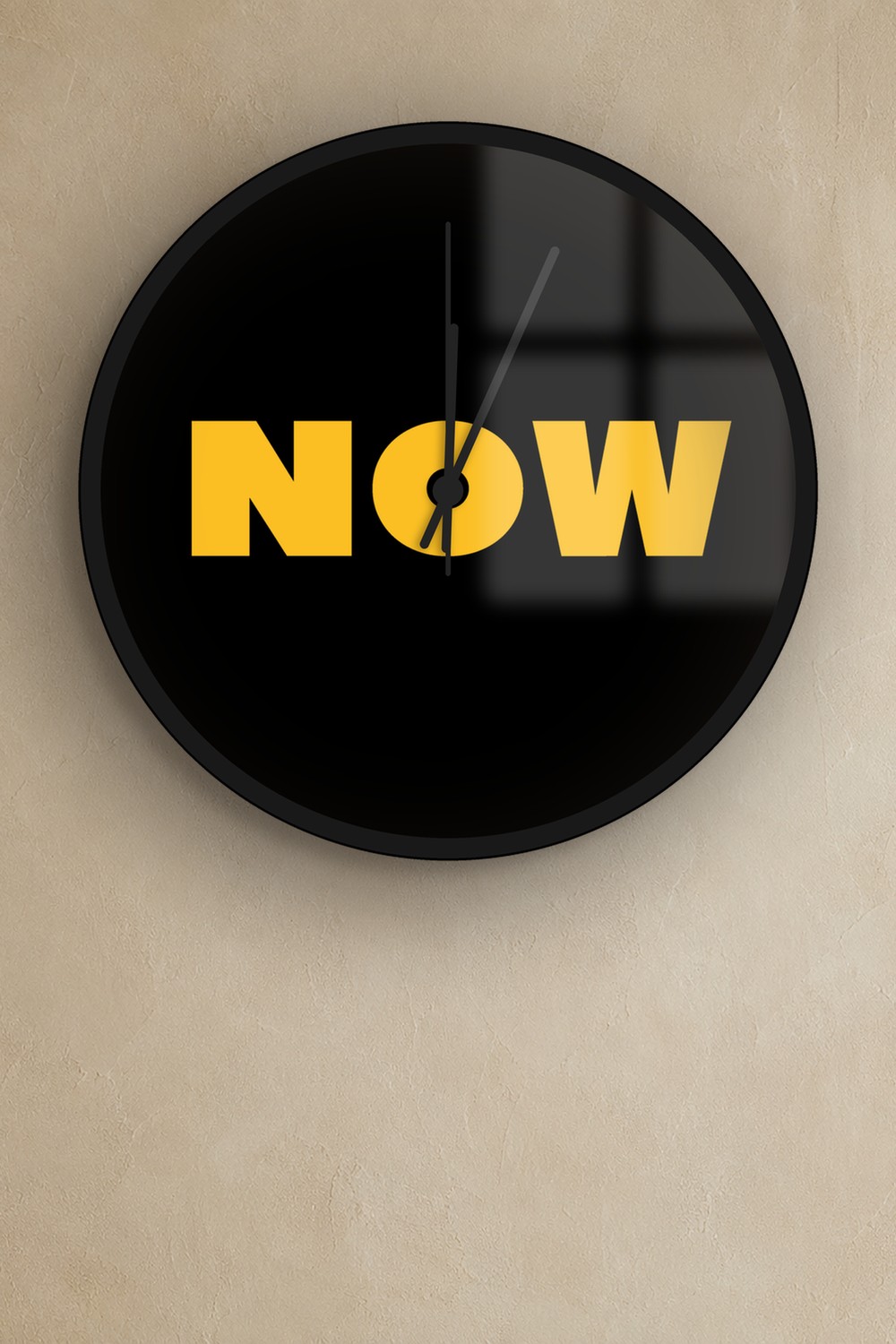 "now" wall clock in black and honey, on a wall