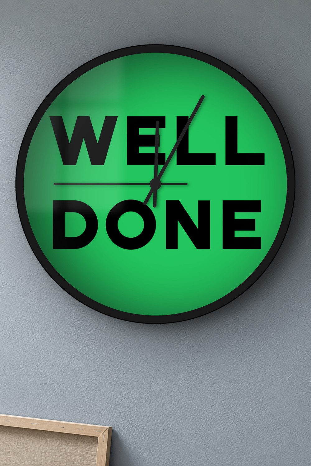 "Well done" wall clock in green and black, on a wall