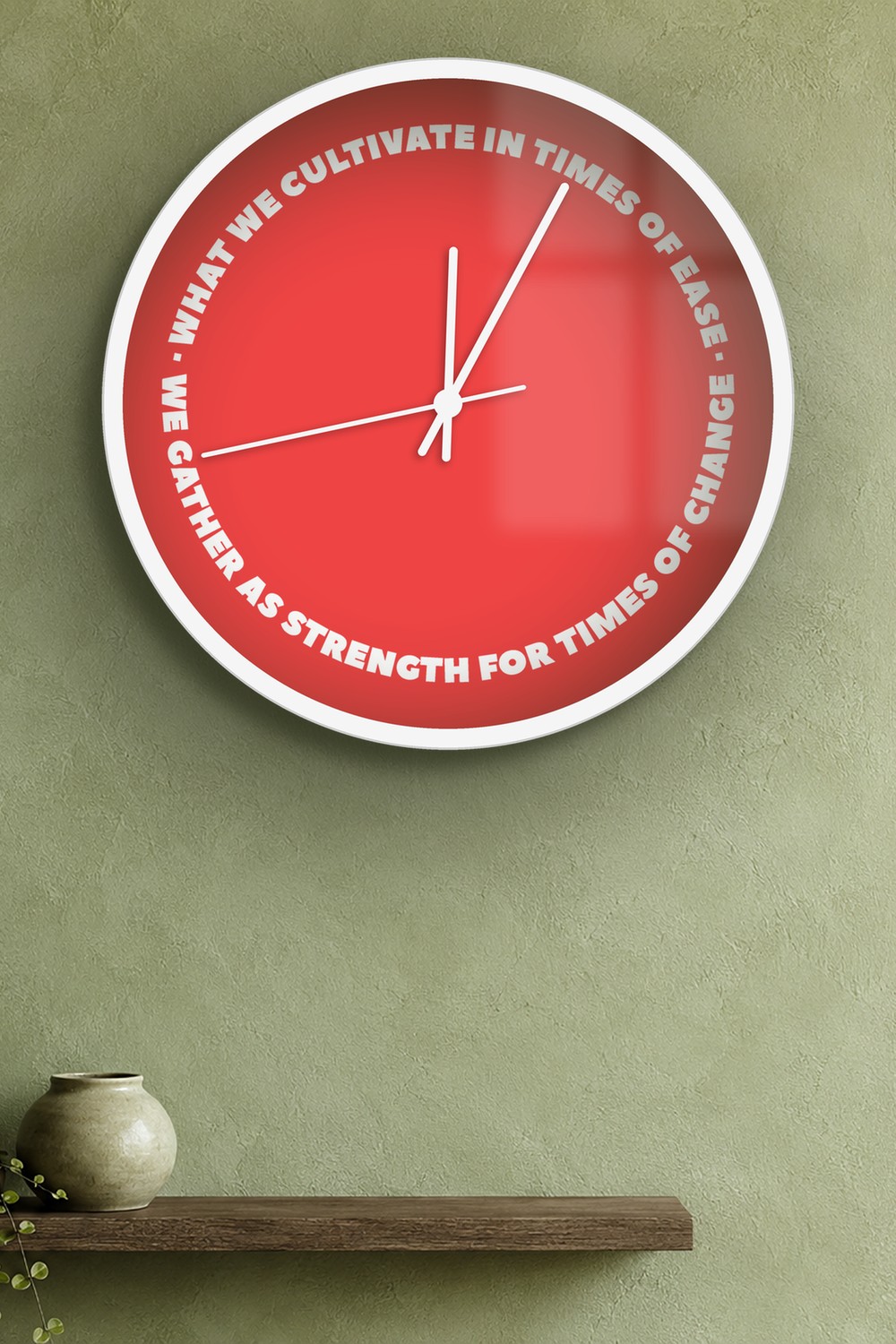 "what we cultivate in times of ease we gather as strength for times of change" wall clock in red and white, on a wall