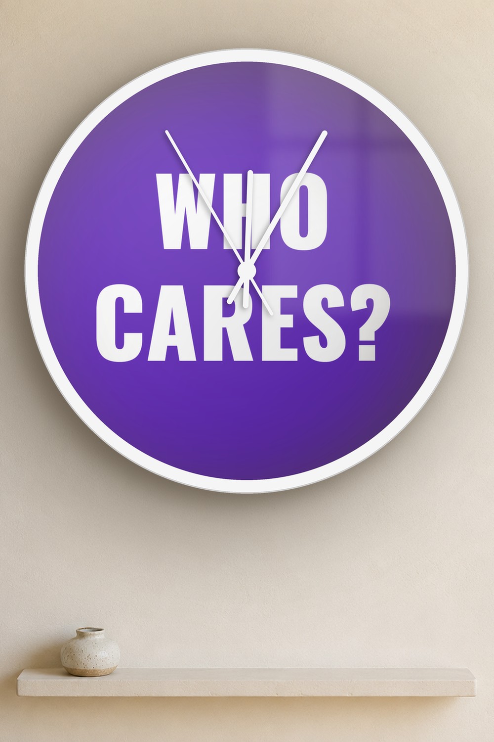 "Who cares" wall clock in dark violet and white, on a wall