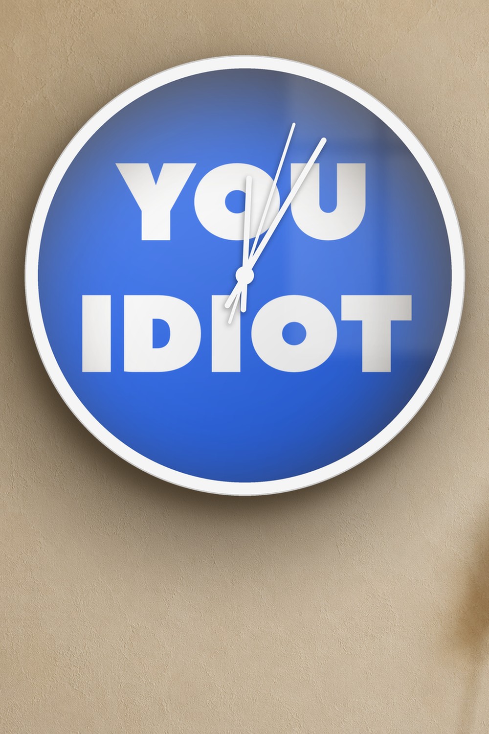 "You idiot" wall clock in blue and white, on a wall