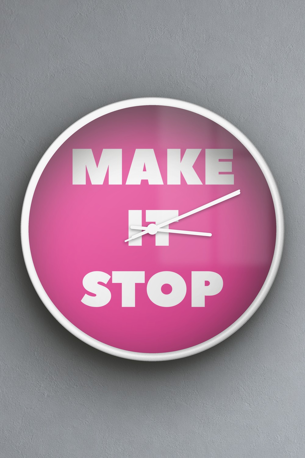 "Make it stop" wall clock in pink and white, on a wall